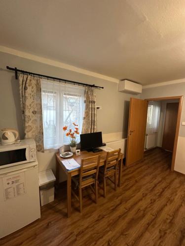 a kitchen with a table with a computer on it at Penzion 4 Dvory in České Budějovice