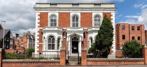 a red brick building with a white facade at SAV Apartments Regent Leicester in Leicester