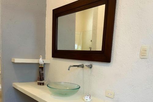 a bathroom sink with a glass bowl on it at Kastelorizo Private Beachfront house in Chicxulub