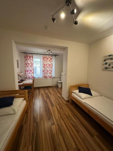 a large room with two beds and a window at Penzion 4 Dvory in České Budějovice