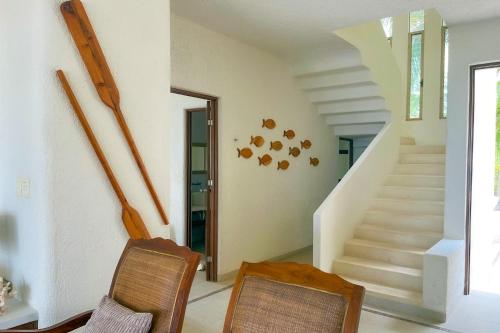 two chairs and a staircase in a house at Kastelorizo Private Beachfront house in Chicxulub
