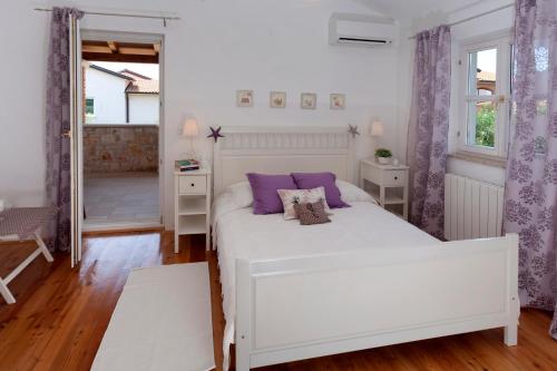 מיטה או מיטות בחדר ב-Villa Mia Lea