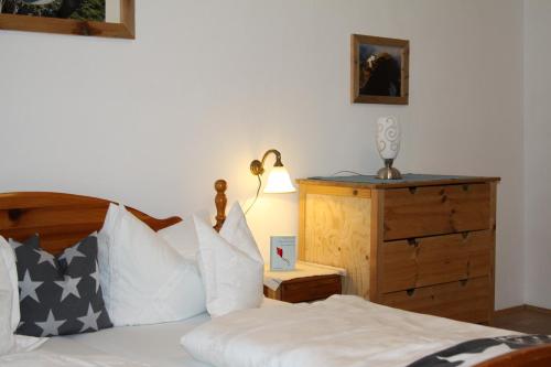 a bedroom with a bed and a lamp and a dresser at Schönfeldjoch in Bayrischzell
