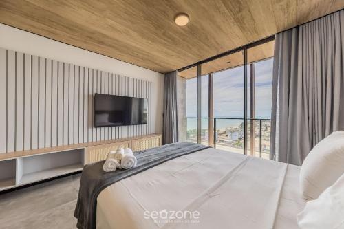 Giường trong phòng chung tại NWTs - Estúdios com Vista Lateral Mar em Maceió II