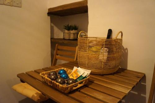 a basket of eggs sitting on a wooden table at Eftychia's House in Lofou