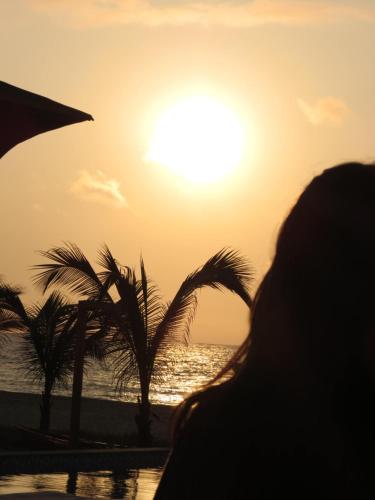 a person watching the sunset at the beach at Las Hamacas in Canoas De Punta Sal