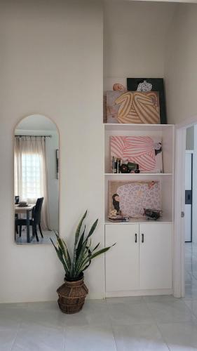 a room with a table and a mirror and a plant at Irie Rock Cottage - Close to the Beaches and Attractions, Spa Treatment- Discovery Bay, St Ann in Discovery Bay