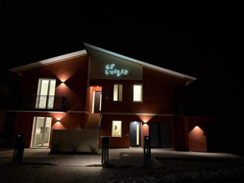 a building with a sign on it at night at Villa San Biagio Residence in Mason Vicentino