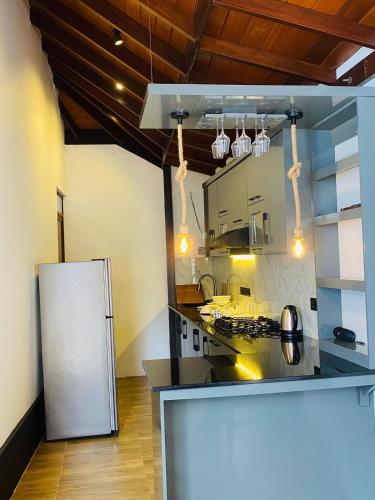 a kitchen with a white refrigerator in a room at Villa Navodi in Negombo