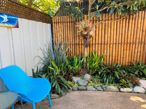 a blue chair sitting in front of a fence at The Beach Pad in Auckland