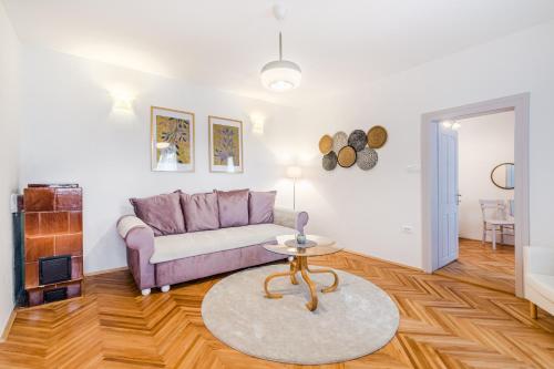 a living room with a couch and a table at Apartment Vandora in Idrija