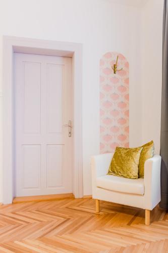 a white room with a white door and a white couch at Apartment Vandora in Idrija
