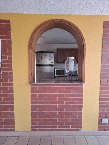 a brick wall with an arch in a kitchen at House Life in La Calera