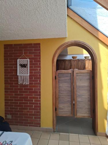 an entry to a house with an archway and a wall at House Life in La Calera