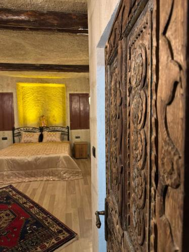 an open door to a bedroom with a bed at Colina Stone House in Mustafakemalpaşa