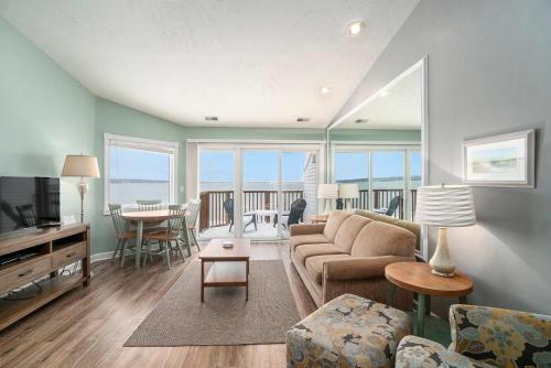 a living room with a couch and a table at Beachside 325 Waterfront Condo in Traverse City
