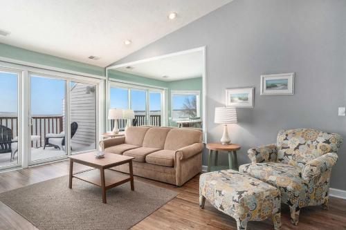 a living room with a couch and a chair at Beachside 325 Waterfront Condo in Traverse City