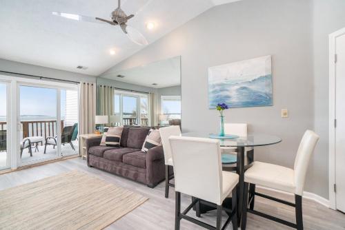 a living room with a table and a couch at Beachside 323 Waterfront Condo in Traverse City