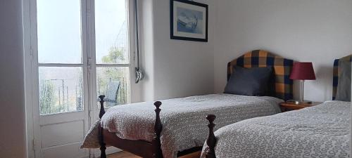 a bedroom with two beds next to a window at João 3 in Lisbon