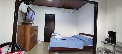 a bedroom with a bed with a mirror in it at Casa Independiente Único in Villavicencio
