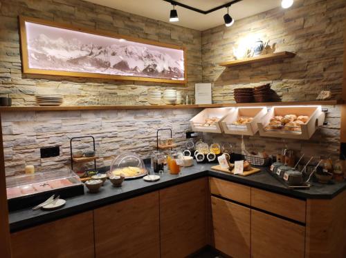a kitchen with a counter with food on it at Frühstückspension Auer - Haus Kargl in Schladming
