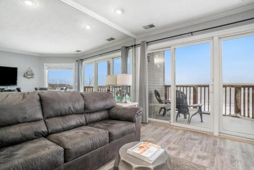 a living room with a couch and a large window at Beachside 218 Luxury Condo on the Beach in Traverse City