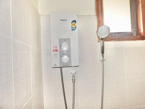 a shower in the corner of a bathroom at Fahluang Resort in Chiang Phin Self Help Settlement