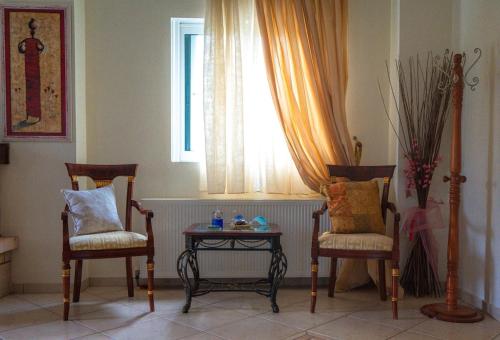 a room with two chairs and a table and a window at Villa Despoina in Platamonas