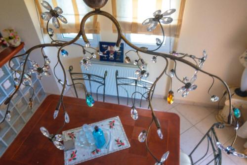 a chandelier with ornaments on a table in a room at Villa Despoina in Platamonas