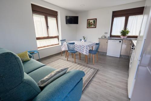 a living room with a couch and a table with chairs at Casa Melina in Villapedre