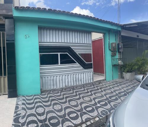 a garage with a car parked in front of it at Casa Paraisso in Ananindeua