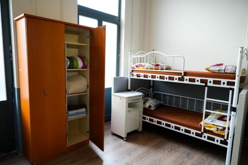 a room with two bunk beds and a closet at YOUR HOSTEL midi station in Brussels
