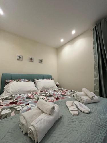 a bedroom with a bed with towels and surfboards on it at Foder'House Design Suite in Agrigento