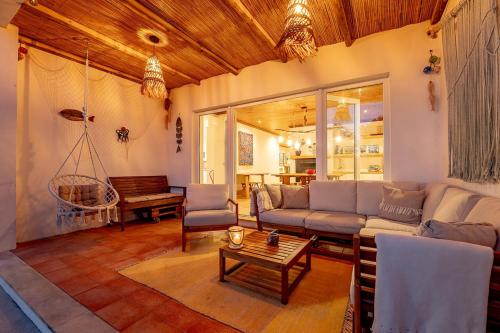 a living room with a couch and a table at RiaEncontros- Villa T4 junto Ria e Pinhal in Aveiro