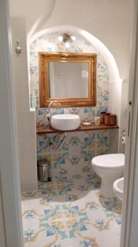 a bathroom with a sink and a toilet at Dimora San Pietro a Corte in Salerno