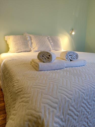 a white bed with two towels on top of it at Quinta da Padrela Vineyard House in Tabuaço