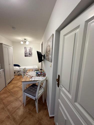 a room with a table and a chair and a door at Penzion 4 Dvory in České Budějovice