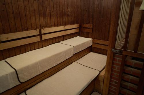 a room with two beds in a sauna at Dormy Inn Higashi Muroran in Muroran