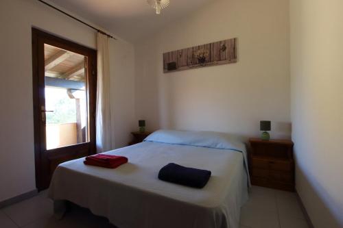a bedroom with a bed with two towels on it at Villette Oasi in San Teodoro