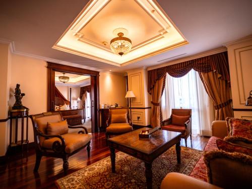 a living room with a couch and chairs and a table at Plaza Grande Hotel in Quito