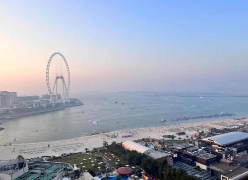 an aerial view of a beach with a ferris wheel at Ahlan New Horizon JBR in Dubai
