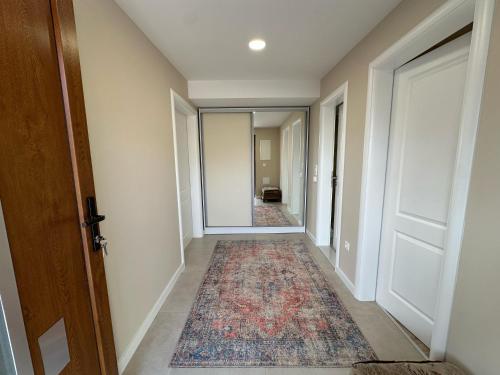 an empty hallway with a rug on the floor at Apartments 16th Street in Mostar