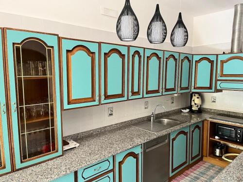 a kitchen with blue cabinets and a sink at Villa Annette #Vivere la Puglia in Villa Castelli