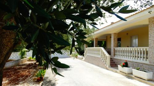a house with a tree in front of it at Villa Annette #Vivere la Puglia in Villa Castelli