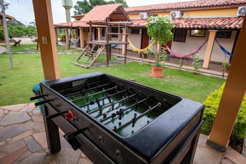 a ping pong table in a backyard with a playground at Hotel Pantanal Mato Grosso in Poconé