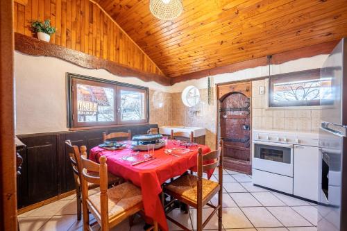 a kitchen with a table with a red table cloth at Chalet les aiguilles in Albiez-Montrond