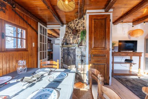 a dining room with a table and a fireplace at Chalet les aiguilles in Albiez-Montrond