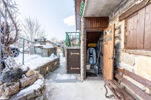 an open door of a building with snow on the ground at Chalet les aiguilles in Albiez-Montrond