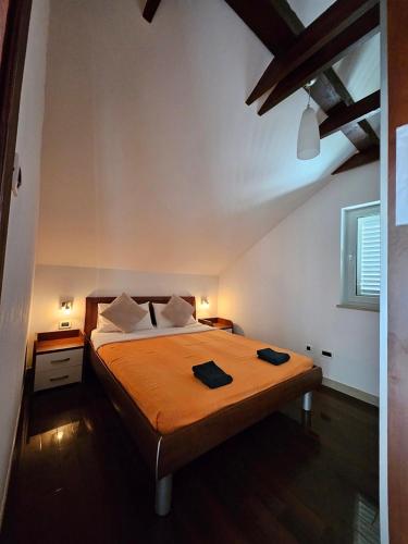 a bedroom with a bed with two towels on it at Villa Jade Apartments FRONT ROW SEA VIEW - WALK TO KORCULA OLD TOWN in Korčula