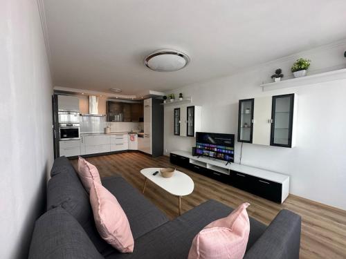 a living room with a couch and a table at High rise cozy 2BRD flat in Prague